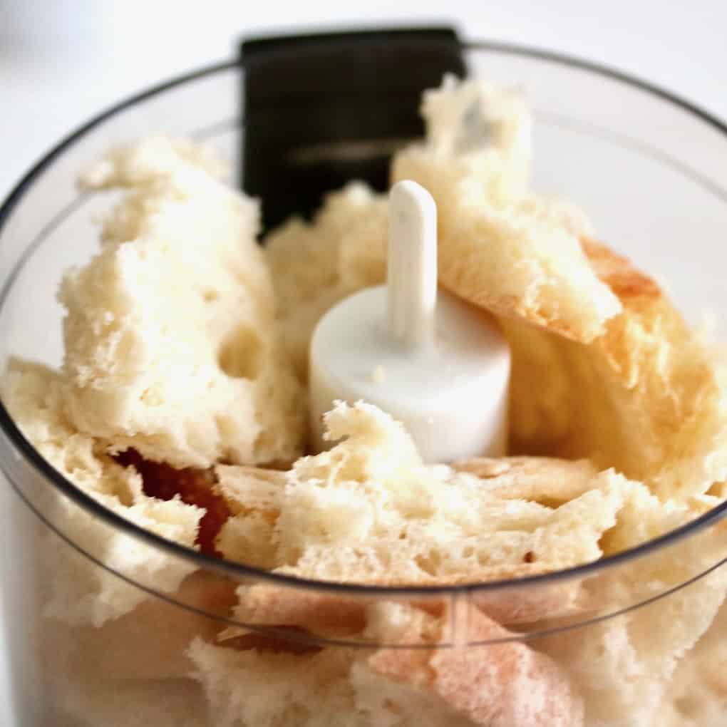 Torn stale bread in a food processor.