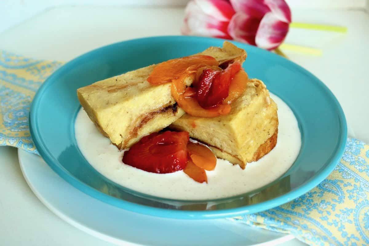 Wedges of white chocolate bread pudding with fruit.