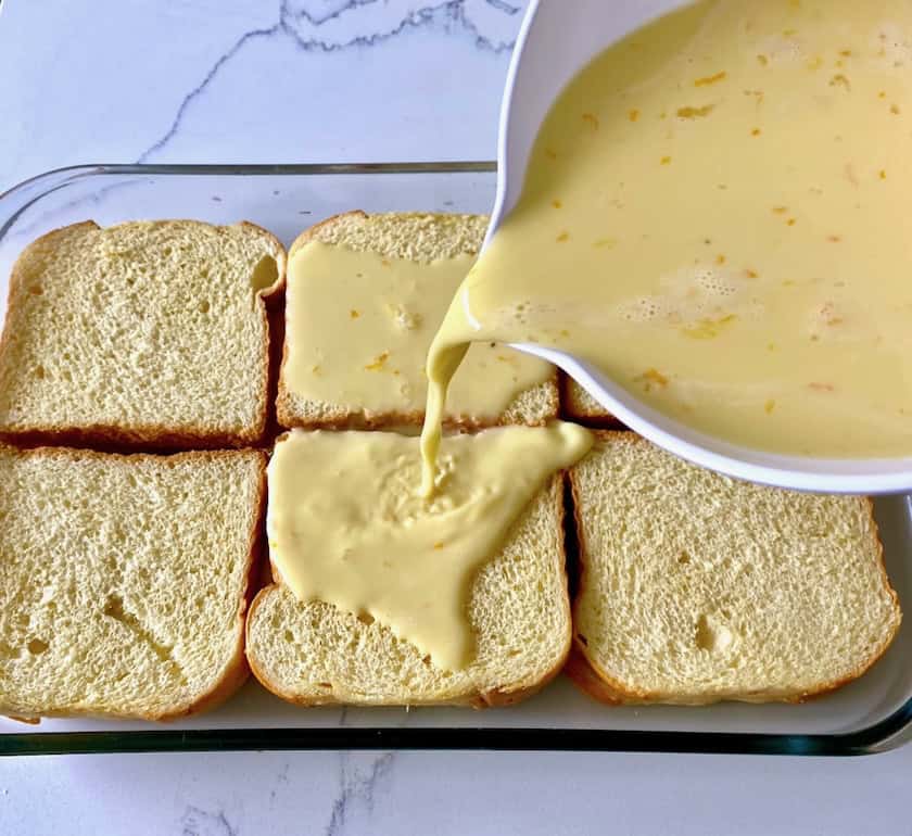 Pouring custard over bread.