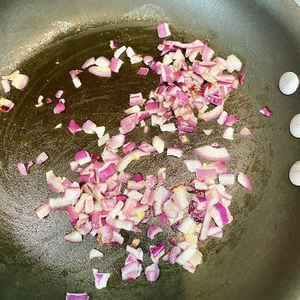 Cooking diced purple onions.