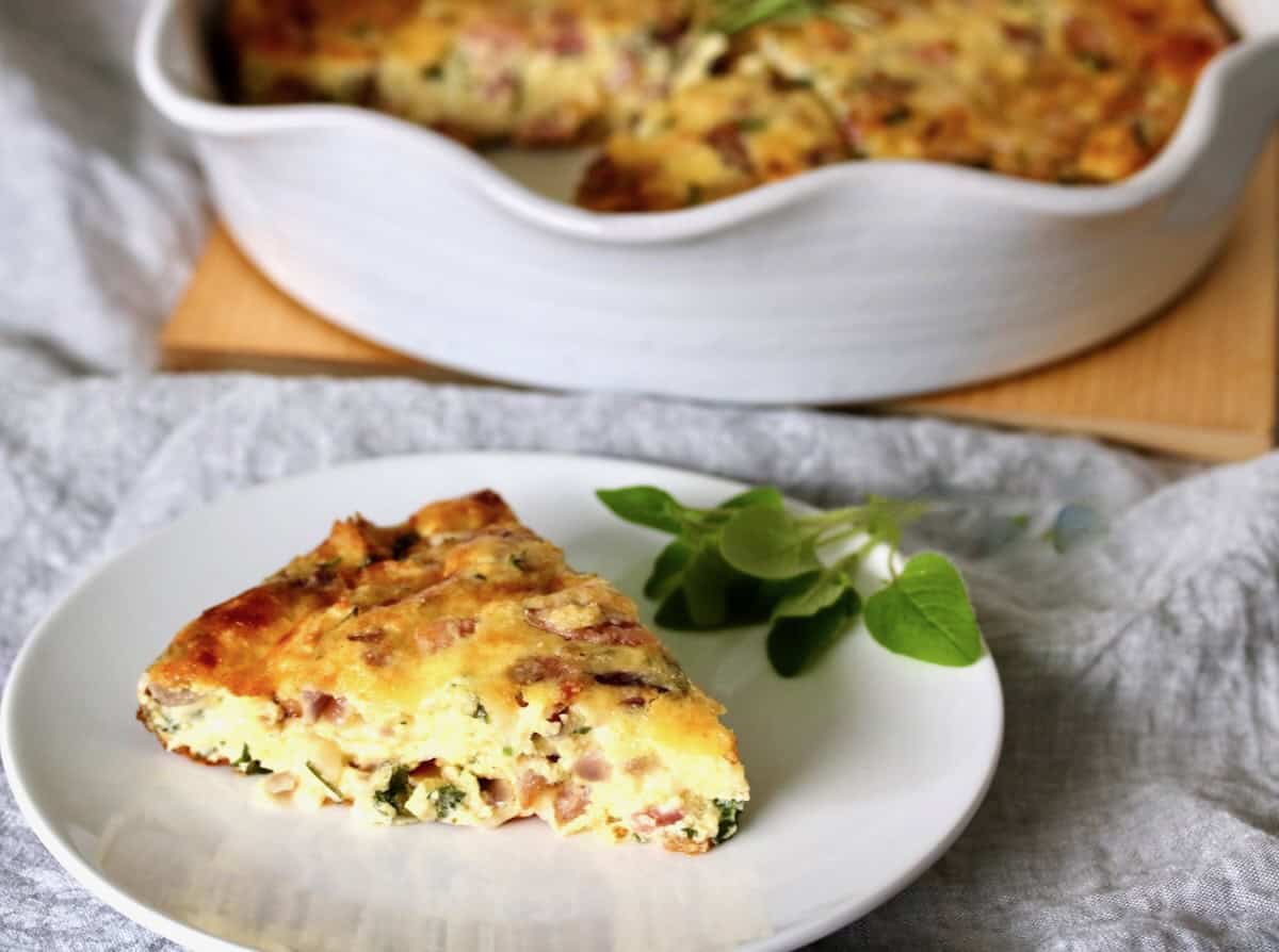 Slice of crustless ham and cheese quiche.