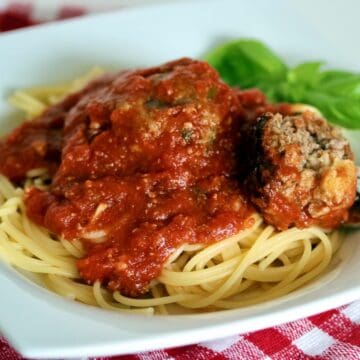 Plate of spaghetti and fried Italian meatballs.
