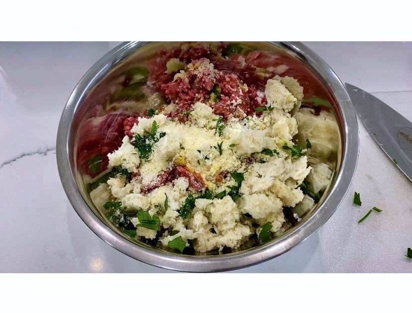 Beef meatball ingredients in a bowl.
