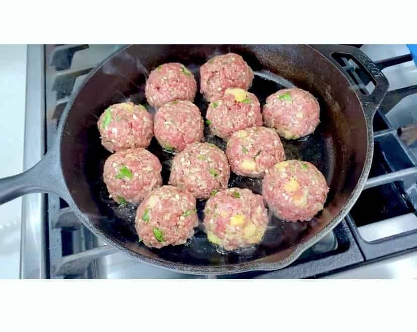 Frying Grandma's authentic Italian meatballs.