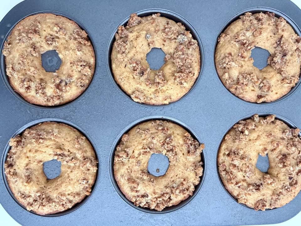 Six baked apple donuts.