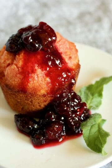 A crumb cake with raspberry sauce on top.