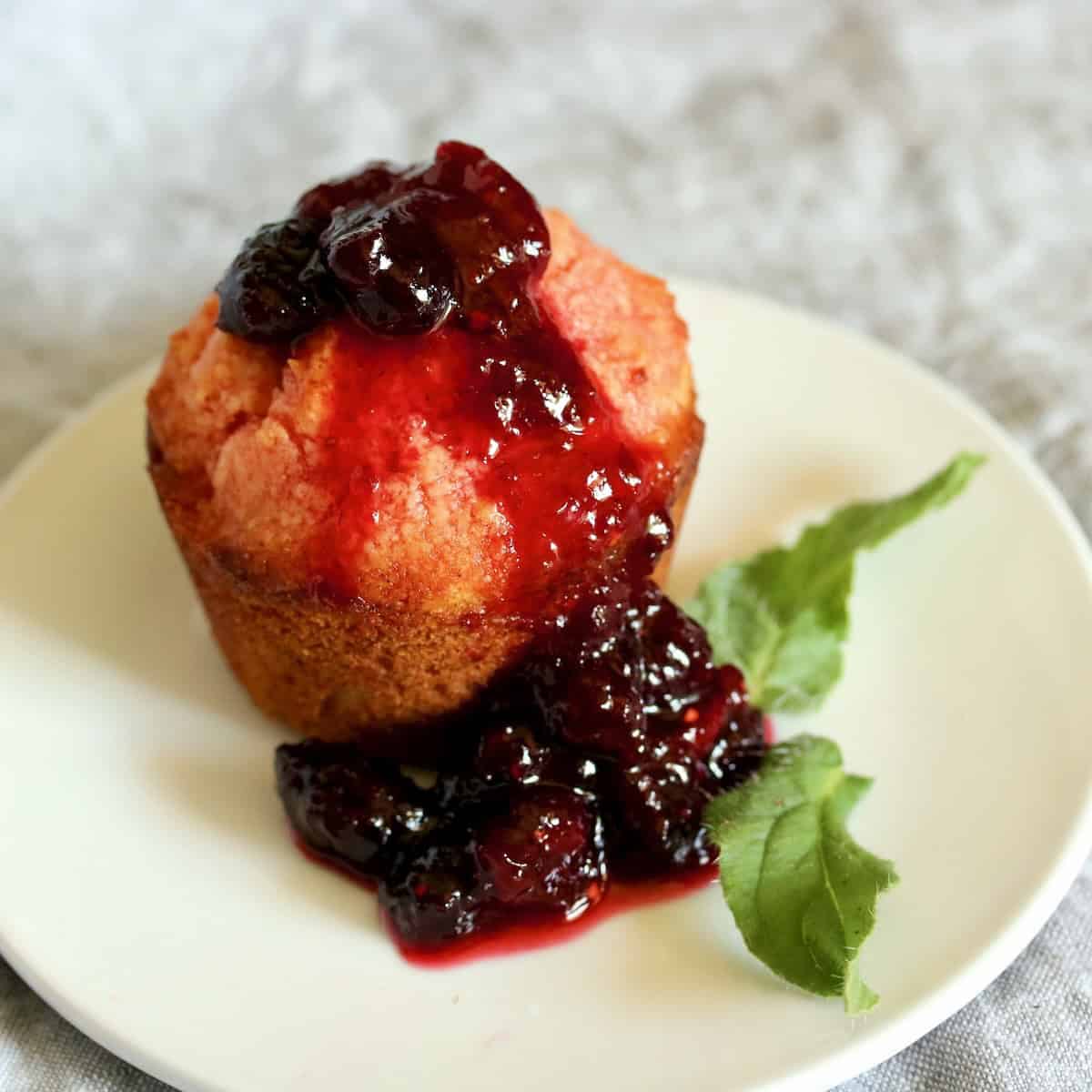 A crumb cake with raspberry sauce on top.