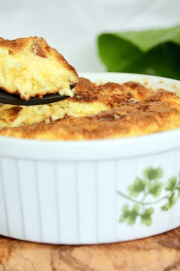 A spoon of cheese soufflé with prosciutto..