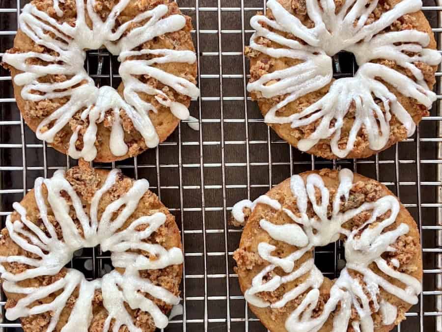 Four cinnamon swirl apple crumb donuts.