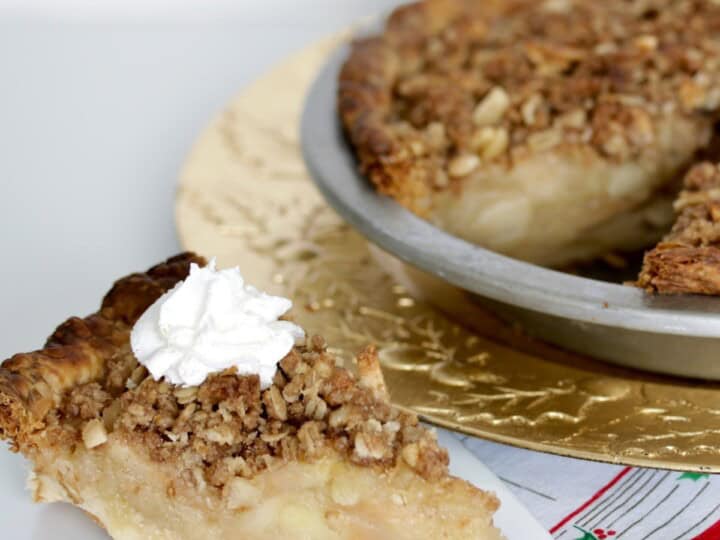 Delicious apple crumb pie topped with crunchy streusel and whipped cream, perfect for holidays or cozy gatherings.