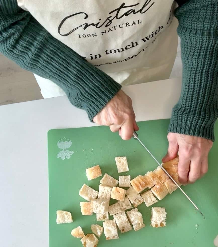 Slicing bread into bite-size pieces.