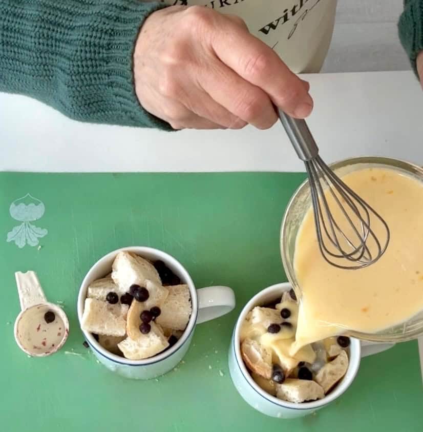 Making microwavable mug bread pudding with wild blueberries.