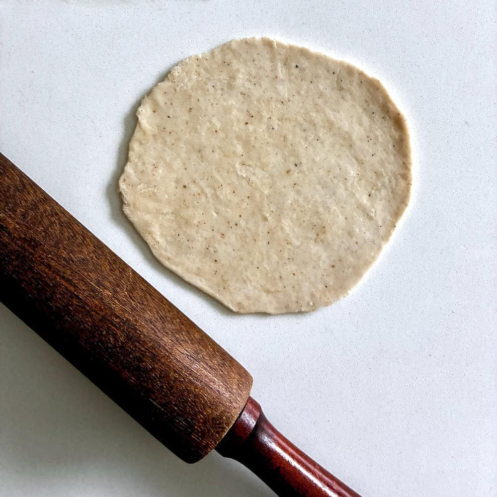 Rolling out Bengali fry bread.