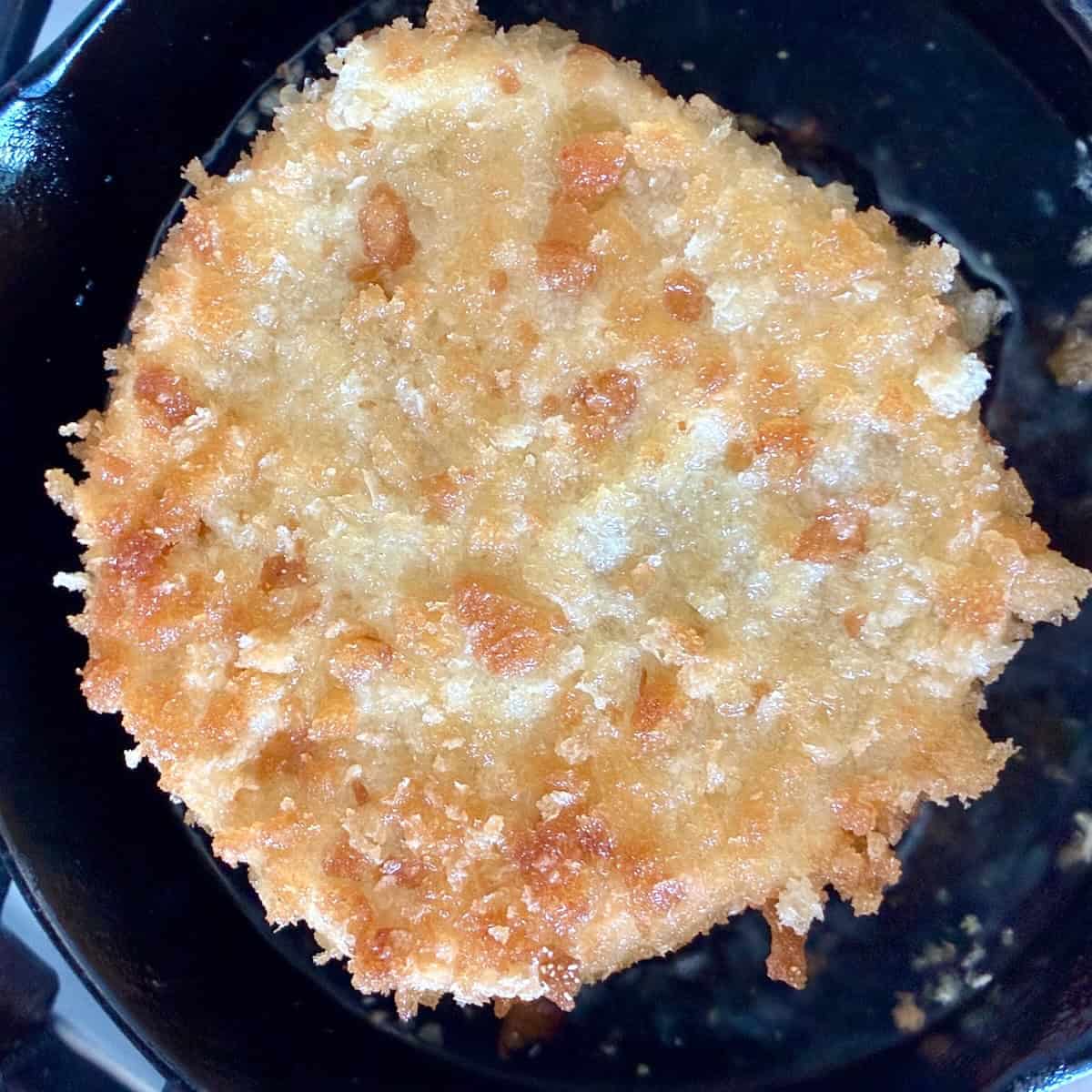 Pizza fritta fry bread in a skillet.