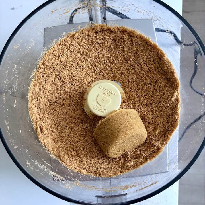 Grinding cookie crumbs and sugar in the food processor.
